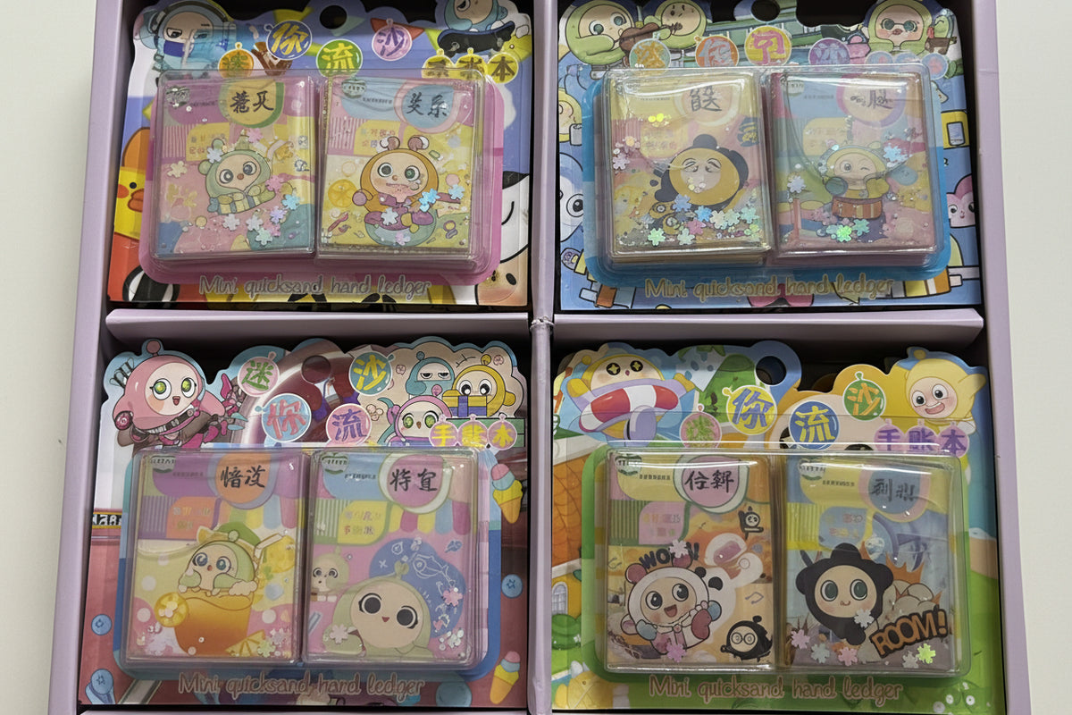 Four packaged cartoon-themed glittery rectangular accessories displayed in a box, each with colorful printed backing cards and clear plastic cases.