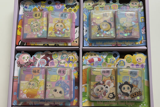 Four packaged cartoon-themed glittery rectangular accessories displayed in a box, each with colorful printed backing cards and clear plastic cases.